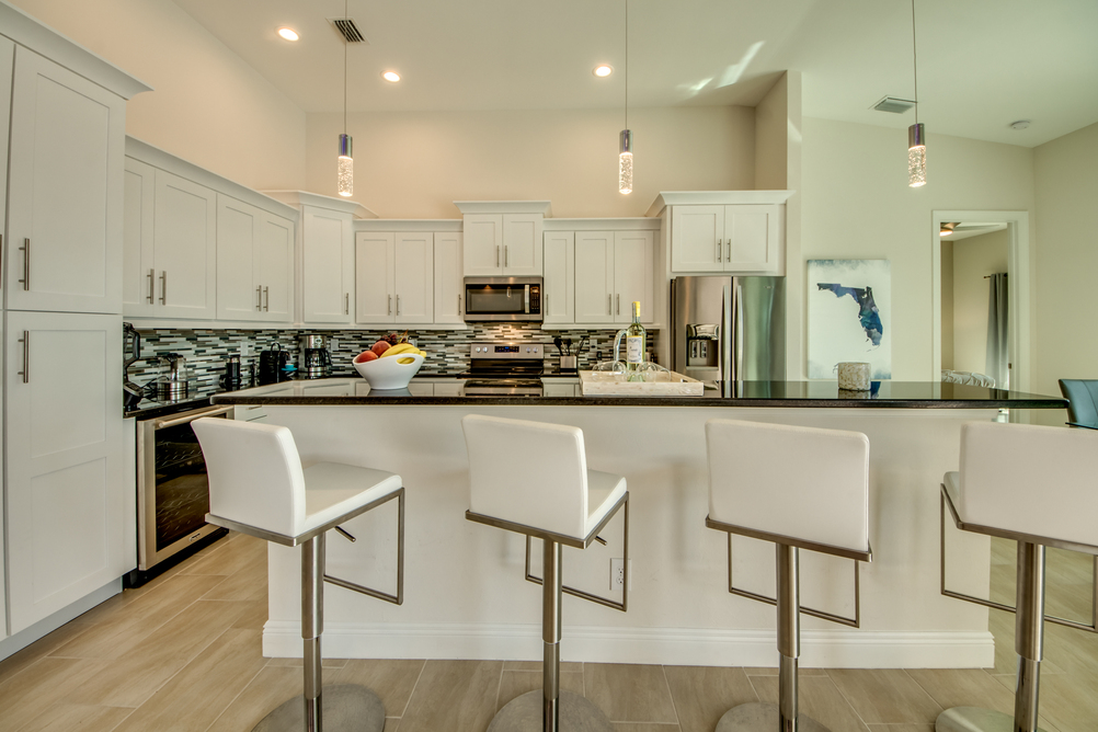 Kitchen with bar stools in Villa Aesthetic