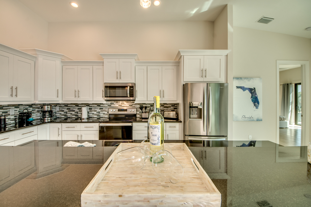 Kitchen with wine glasses and wine in Villa Aesthetic